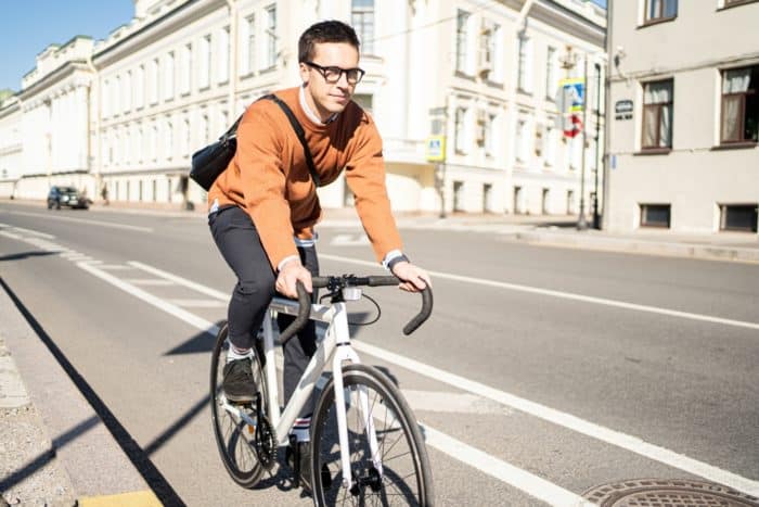 A,male,cyclist,rides,a,bicycle,in,the,city,to